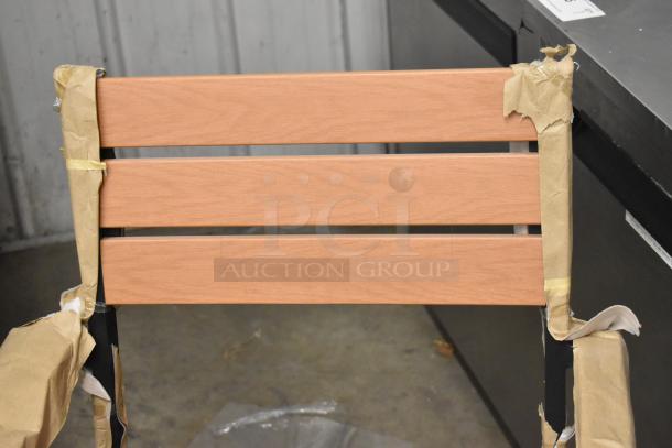 Lancaster Table & Seating black ladder chair, metal frame, wooden backrest, wrapped in packaging. Brand new, 23 available.