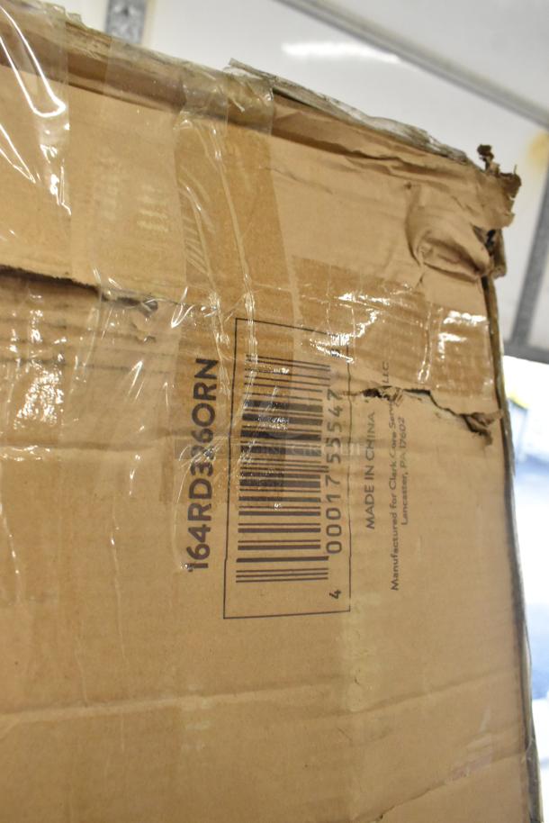 Damaged cardboard box with visible barcode, labeled "164RD360RN," contains new scratch and dent items including a table, wall shelf, and work table.