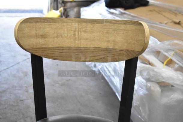 Black metal chair with wooden backrest and cushioned seat. New condition, scratch and dent details. Available in dining and bar height.