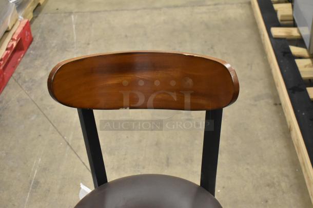 14 black metal chairs with wooden backrest and cushioned seat. Includes dining and bar height, scratch and dent condition.