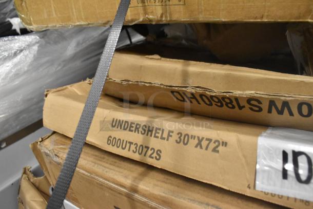 Cardboard box marked "UNDERSHELF 30"X72" 600UT3072S" with visible dents, part of a scratch and dent auction lot.