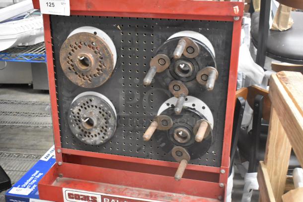 Coats red metal floor-style balancer on casters, displaying multiple balancing components; shows signs of wear.