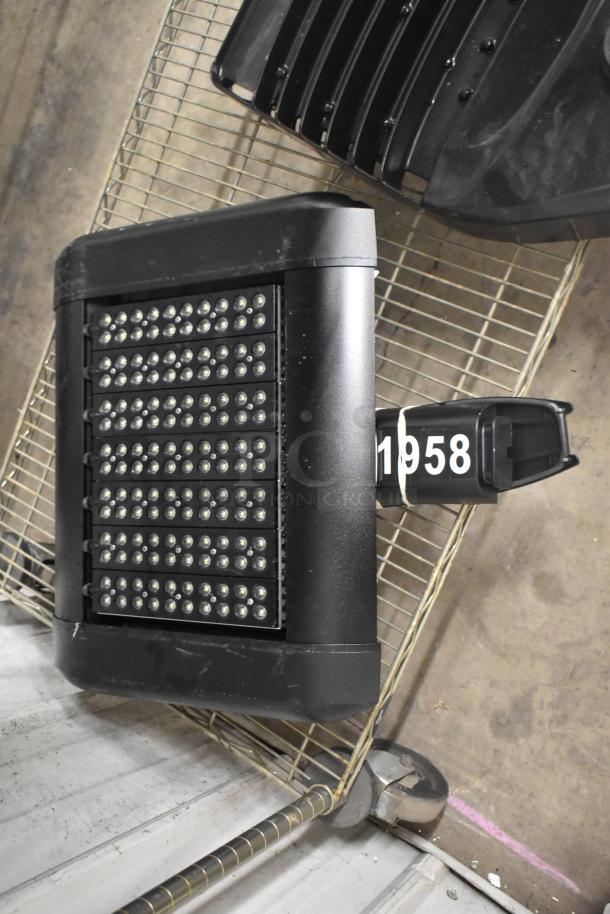 Brand new light fixture with minor scratches and dents. Features LED array. Tagged with number 1958.