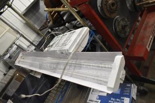 Brand new Westinghouse RMSP501D-08 5000 Lumen LED shop light and Lithonia light, minor dents, label lot 128.