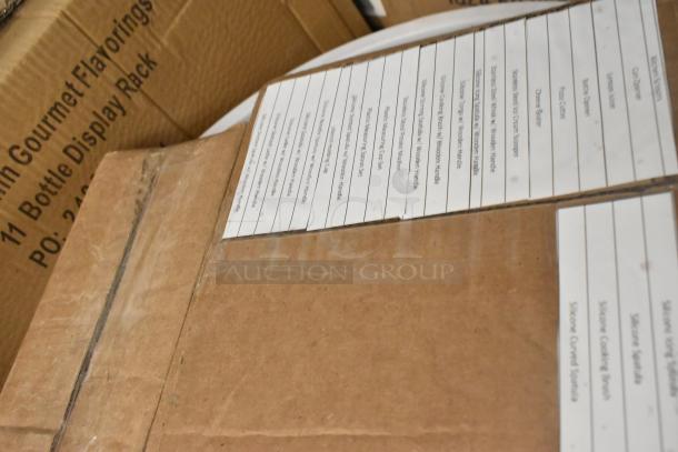 Cardboard boxes with visible labels listing items like silicone spatulas and measuring spoons. Condition: new scratch and dent.