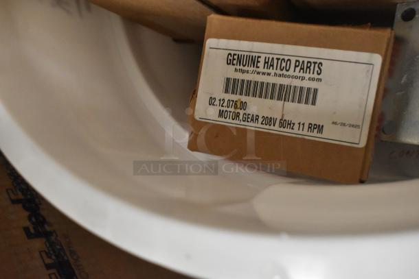 Cardboard box labeled "Genuine Hatco Parts," containing a motor gear, 208V 60Hz 11 RPM, on a white surface.