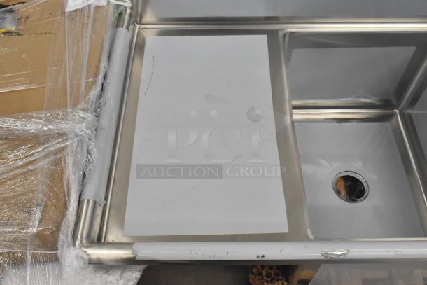 Brand new Regency 600S31824218 stainless steel 3-bay sink, dual drain boards, scratch and dent condition, no legs.