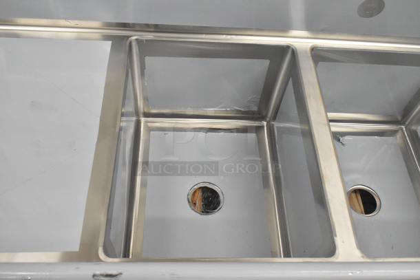 BRAND NEW Regency 600S31824218 stainless steel 3-bay sink with scratches; includes dual drain boards, no legs.