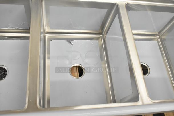 Regency 600S31824218 stainless steel 3-bay sink with dual drain boards. Scratch and dent condition. No legs included.