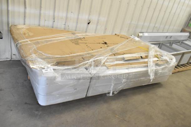 Five new scratch and dent Regency 36"x96" stainless steel commercial work tables with undershelf, wrapped for transport.