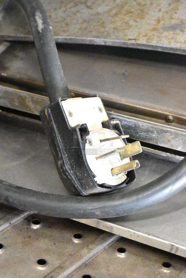 Close-up of a power plug and cord for a Turbochef HhC2020 commercial conveyor oven. Plug is 208/240 volts, 3-phase.