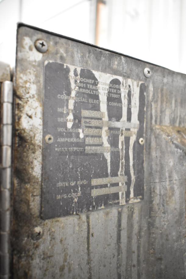 Turbochef HhC2020 stainless steel conveyor oven label showing model, voltage, and power specs. Visible wear.