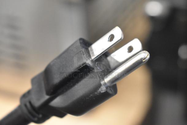 La Marzocco Swift E.P.S.B. metal espresso grinder plug, 120 volts, showing standard prongs for electrical connection.