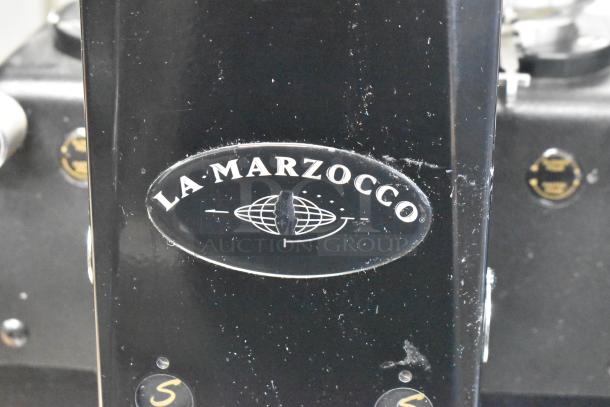 La Marzocco Swift E.P.S.B. commercial espresso grinder, metal finish, dual hoppers, 120V, visible wear, logo plate.
