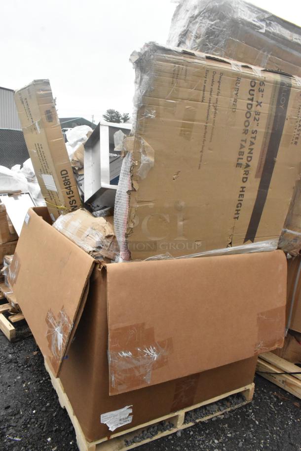 12 new scratch and dent items including boxed outdoor table and shelf on pallets. Packaging shows damage. Signs of wear.