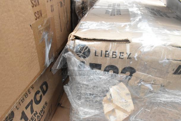 Cardboard boxes labeled "Libbey" with visible packaging, containing scratch and dent items including hand sinks and pot racks.