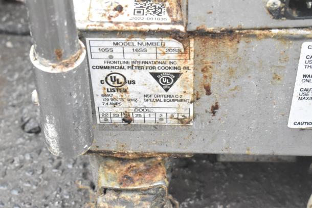 Frontline 10SS stainless steel oil filtration system, commercial casters, visible usage wear, UL and NSF labels shown.