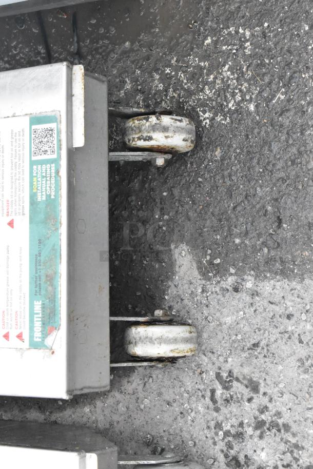 Frontline 10SS stainless steel commercial oil filtration system, visible label with QR code, on used commercial casters.