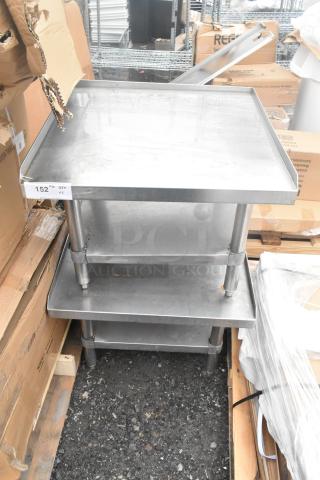 Two stainless steel commercial equipment stands with under shelves, shown stacked. Good condition with a label reading "152 IN QTY."