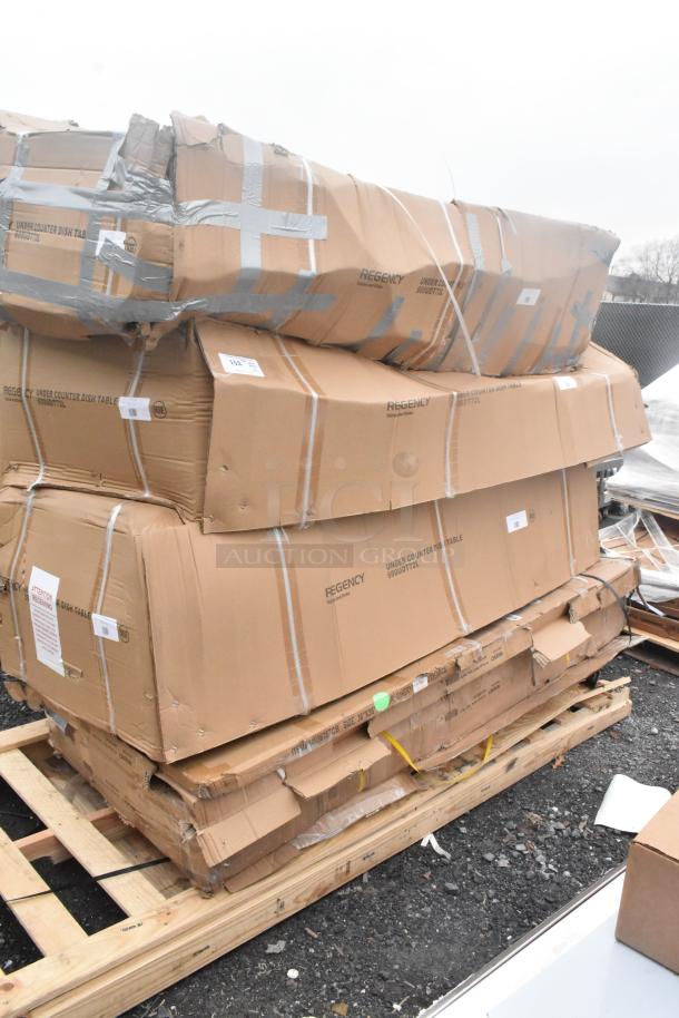 Pallet with 7 new scratch and dent items in boxes, including Regency dishtable and work tables. Packaging slightly damaged.