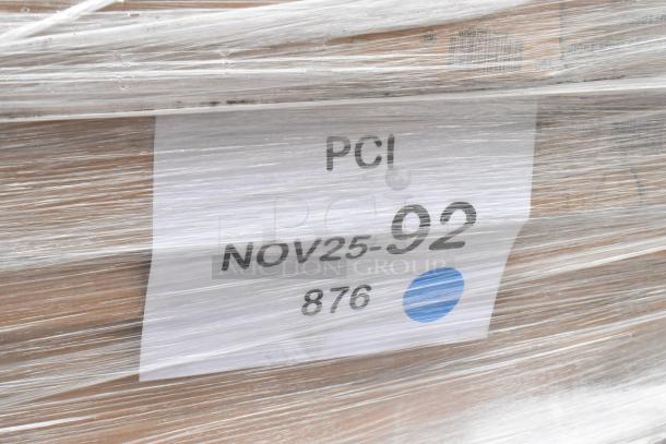 Plastic-wrapped pallet with label showing "PCI NOV25-92 876," containing new scratch and dent items like a work table and wire shelf.
