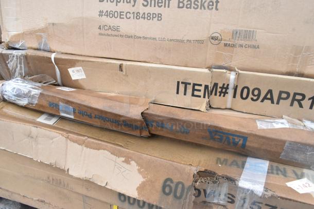 Boxes labeled “Display Shelf Basket” and “Free Standing Smoker Pole” show scratch and dent condition, visible tape and markings.