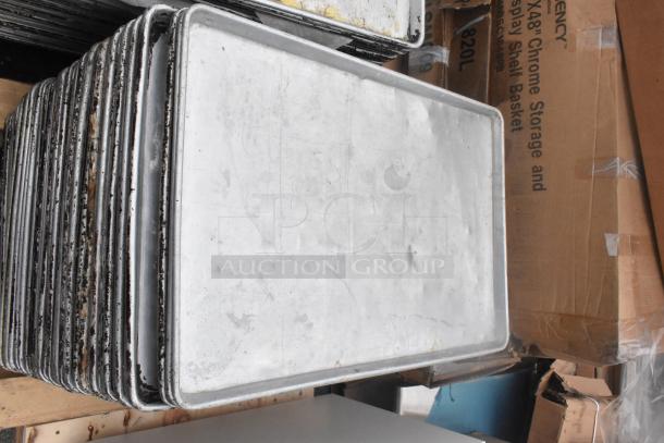 Stack of 106 metal full-size baking pans, used condition, visible wear, ideal for commercial kitchens, auction lot.