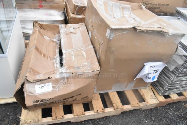 Damaged boxes containing Regency 522CS11818N single bay sink and 460EC1824PB 18"x24" NSF chrome storage basket on a pallet.