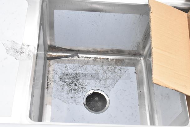 Regency 600S3181818C stainless steel L-shaped 3 bay sink with scratches, dents, and dual drain boards. Brand new.