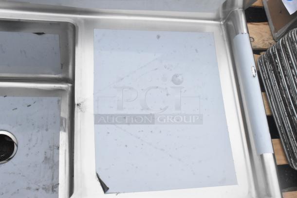 Regency 600S3181818C stainless steel L-shaped 3-bay sink with dual drain boards, visible scratch and dent.