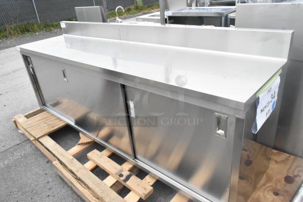 BRAND NEW Regency 600EBTB2496D, 24"x96" stainless steel table with sliding doors, adjustable midshelf, 6" backsplash.