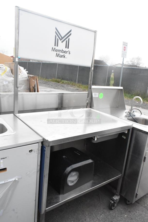 Stainless steel table with drawer, under shelf, and commercial casters. Member’s Mark logo, clean condition.