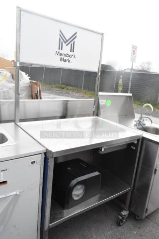 Stainless steel table with drawer, under shelf, and commercial casters. Member’s Mark logo, clean condition.