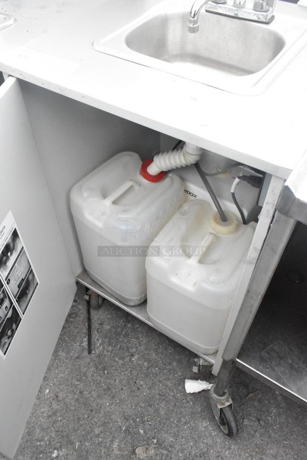 Metal single bay portable sink on commercial casters, featuring a stainless steel counter, under-sink water containers, and faucet.