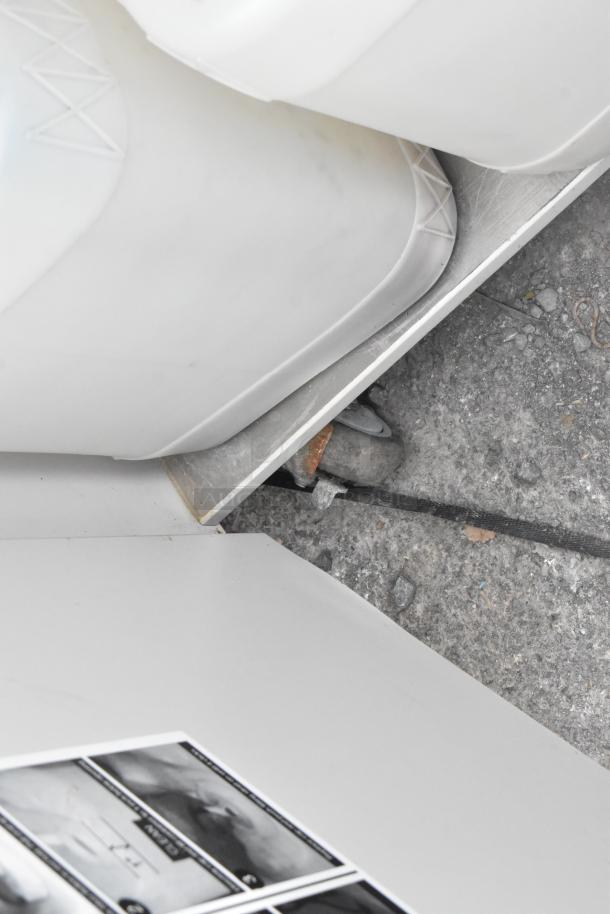 Metal single bay portable sink on commercial casters, featuring durable construction and mobility. Visible wear on casters.