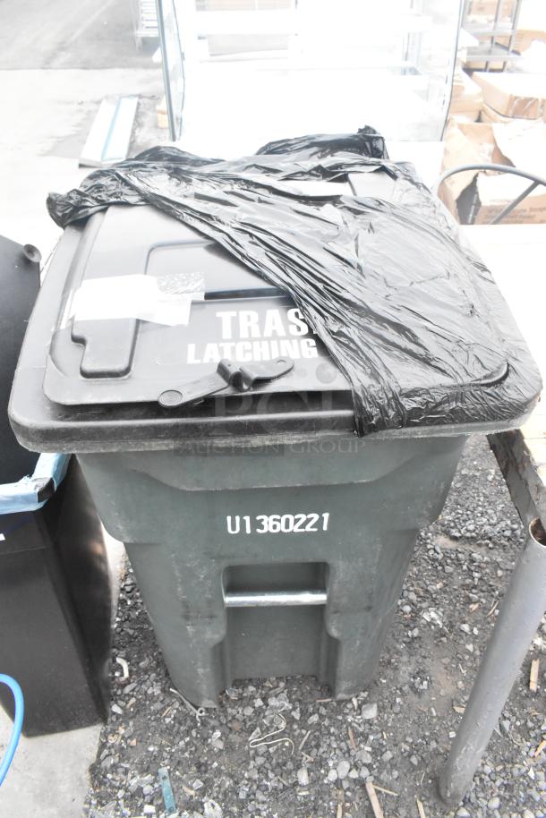 Green poly trash can with latching lid, marked "TRASH LATCHING" and "U1360221." Includes contents, auctioned in pairs.