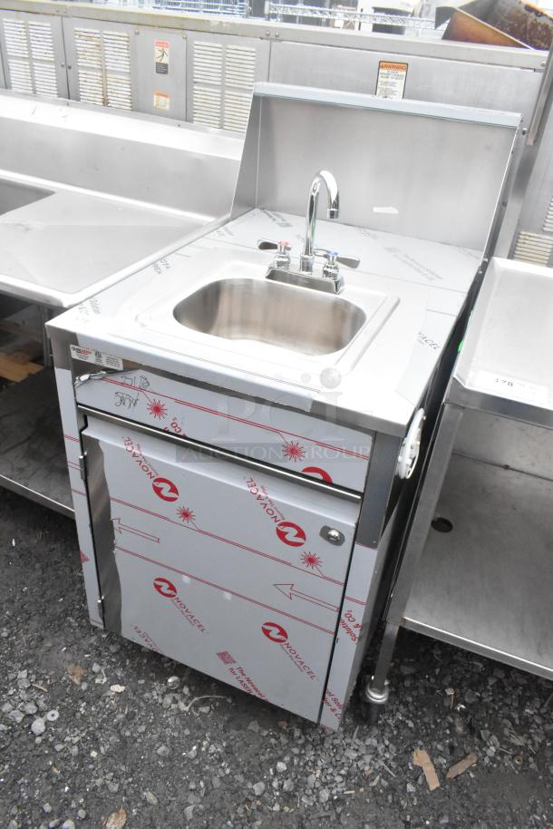 QualServ stainless steel single bay portable sink with commercial casters, protective film intact, labeled by Novacel.