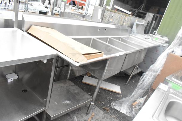 Stainless steel 3 bay sink with dual drain boards and under shelf, excellent condition, ideal for commercial use.