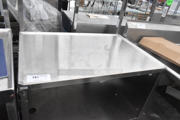 Stainless steel table with undershelf on commercial casters. Features durable construction, ideal for kitchens or workspaces. Visible condition is good.