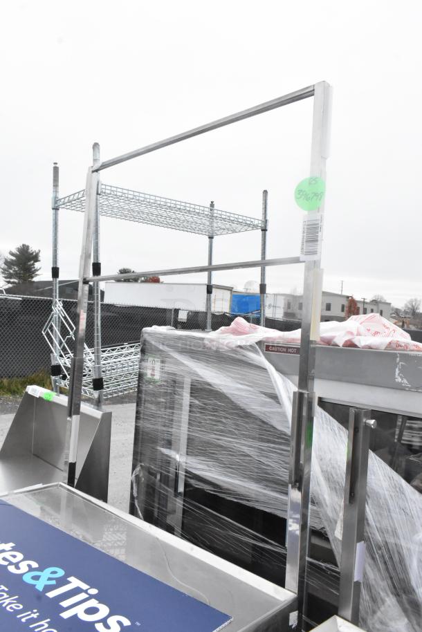Stainless steel table with under shelf and drawer, mounted on commercial casters. Good condition, green price tag visible.