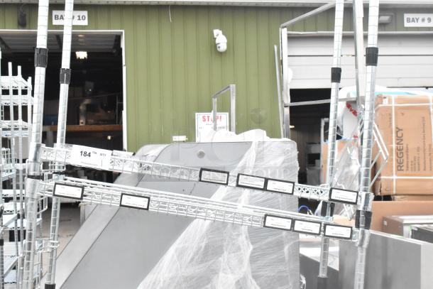Chrome finish shelving unit, dismantled, with labels indicating "184" quantity. Buyer must handle shipping and assembly.