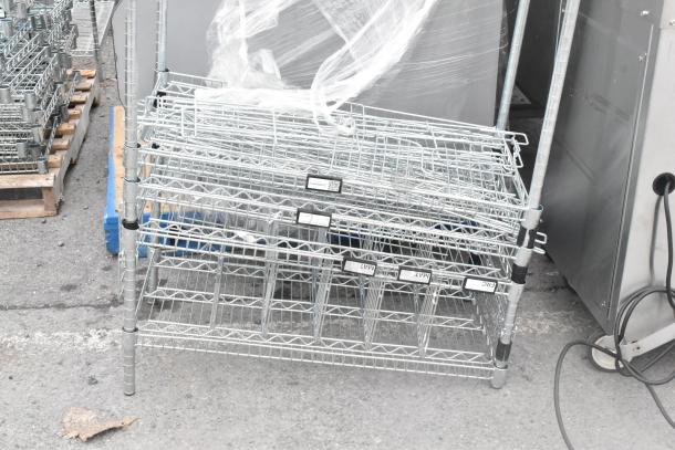 Chrome finish shelving unit, disassembled, with visible labels. Buyer dismantles. Freight charges apply. Excellent condition.