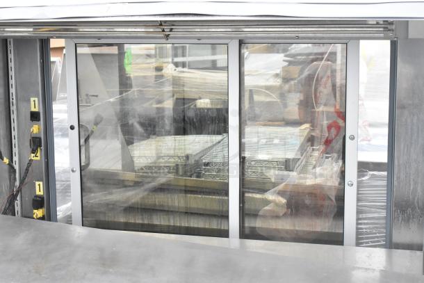 Metal Commercial Reach In Grab N Go Merchandiser with glass doors, metal shelving. Visible wiring and numbered labels. Used condition.