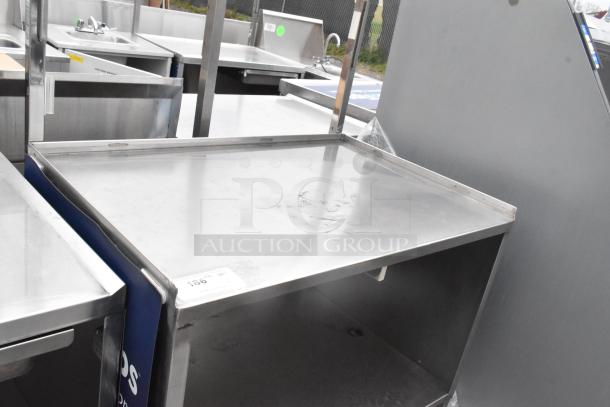 Stainless steel table with under shelf on commercial casters. Features a durable top surface, clean condition, ideal for kitchen use.