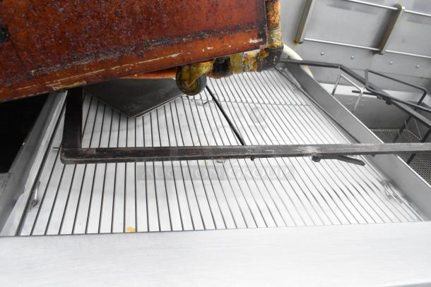 Giles EOF-24 stainless steel commercial electric 3-bay fryer with dumping station, on casters, showing interior grates.