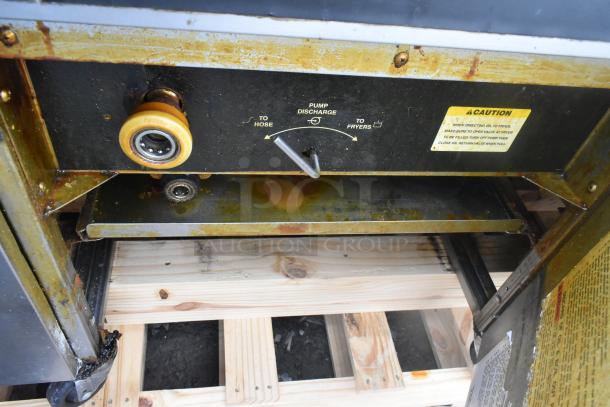 Giles EOF-24 stainless steel electric 3-bay deep fat fryer, pump discharge controls, caution label visible, on wooden pallet.