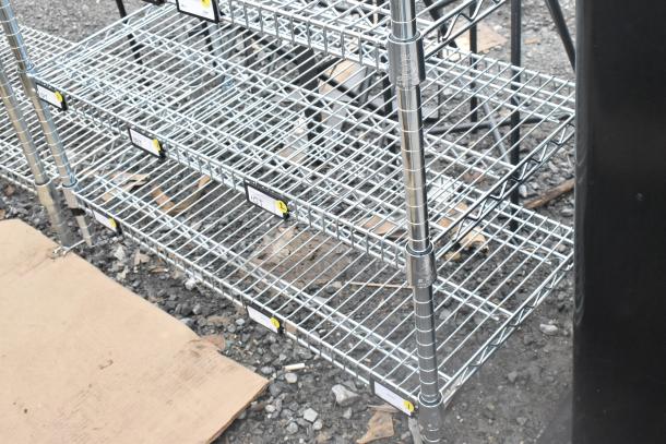 Chrome finish 7 tier wire shelving unit in good condition. Includes visible labels. Buyer must dismantle and consider freight charges.