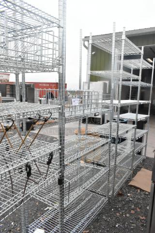 Chrome finish 4 tier wire shelving unit outdoors; buyer must dismantle for shipping; freight charges apply.