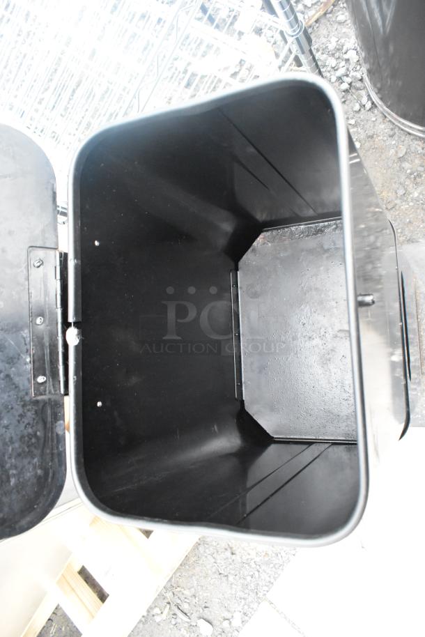 Black trash can interior view, showing spacious, clean condition. Hinges and edges are visible for design detail.