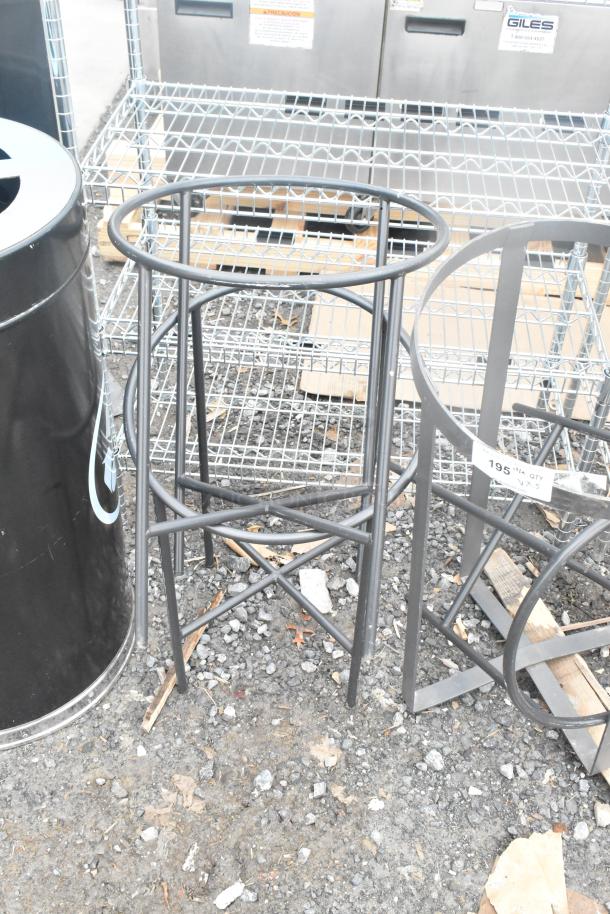 Five assorted metal stands in good condition, varying designs and sizes, ideal for industrial or decorative use.